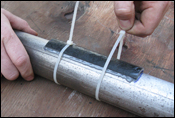 Band FRP pad in place using straps 